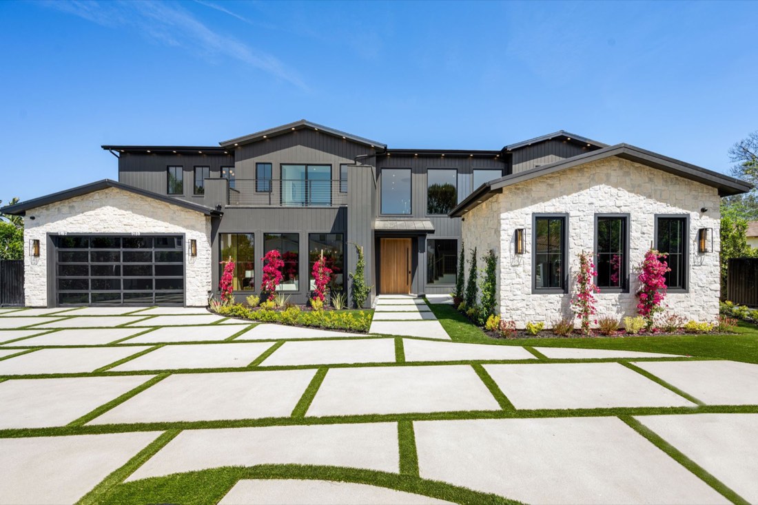 Modern custom home exterior with stone and dark siding