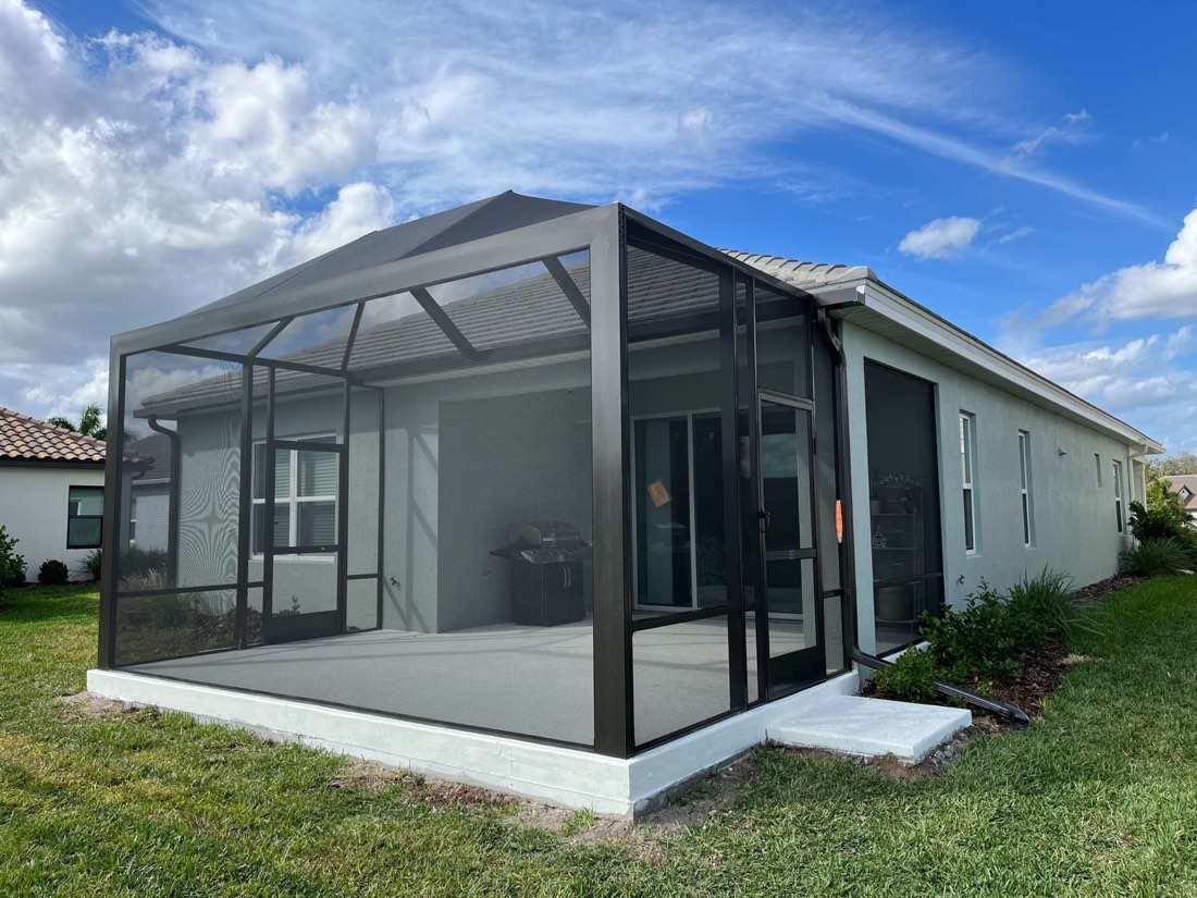 Screened patio enclosure added to the back of a single-story home
